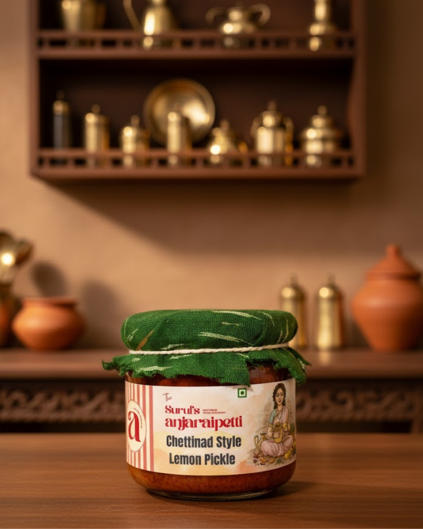 Jar of Chettinad Style Lemon Pickle with a decorative label on a wooden surface.